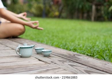 young woman meditating yoga pose teapot stock photo