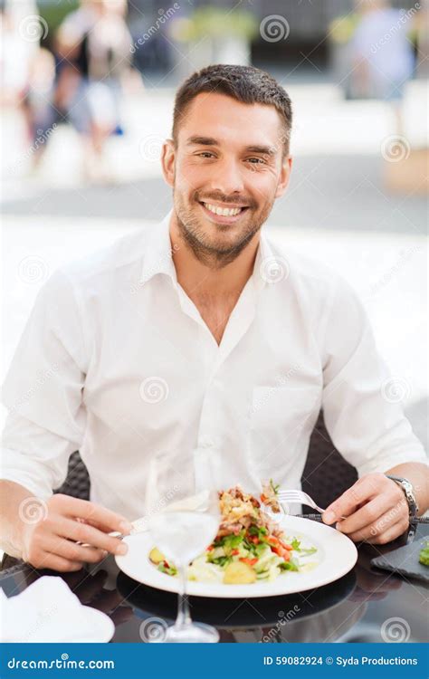 happy man eating salad  dinner  restaurant stock photo image