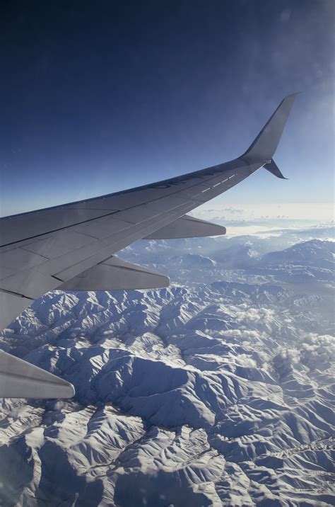 photo  airplane flying  mountains