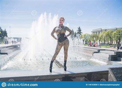 Curvy Blonde Woman With Short Hair Wearing Latex Rubber Catsuit And