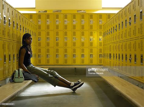 teenage girl sitting in locker room on bench portrait photo getty images