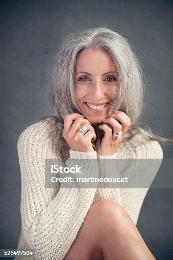 aging gracefully beautiful mature woman with silver hair portrait stock