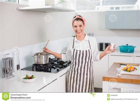 Laughing Pretty Woman With Apron Cooking Stock Image