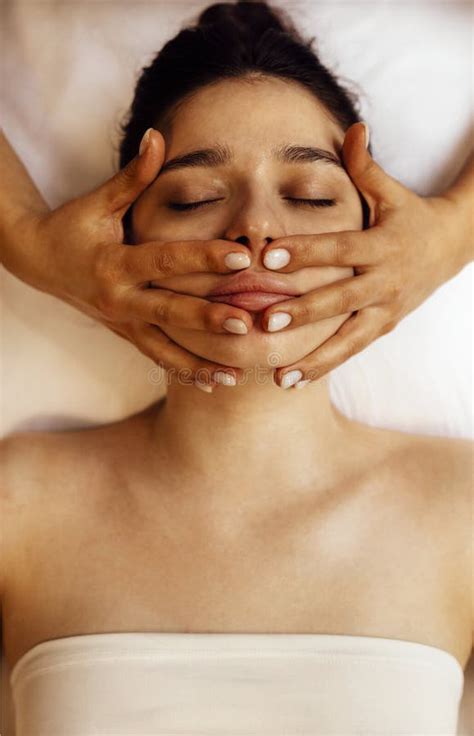 Close Up Portrait Of A Young Beautiful Woman Getting Facial Massage