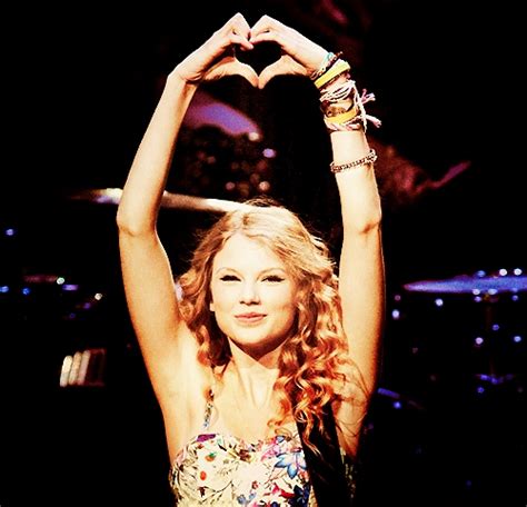 post a pic of taylor where she s making a heart props