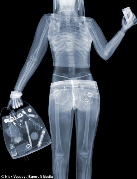 An X Ray Image Of A Woman Holding A Cell Phone And A Plastic Bag