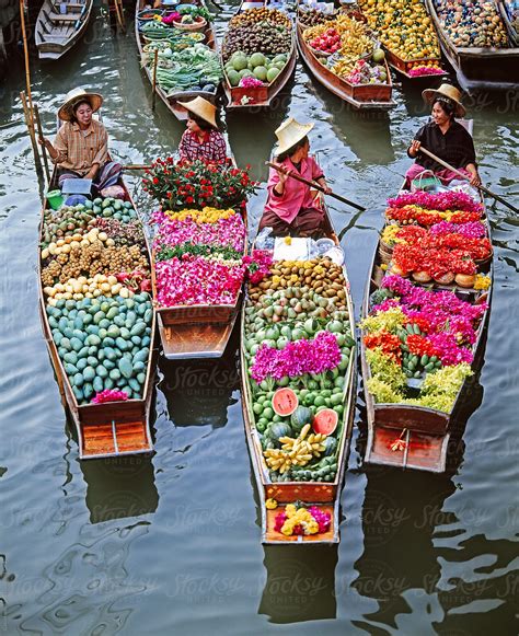 women market traders  boats laden  fruit  flowers damnoen