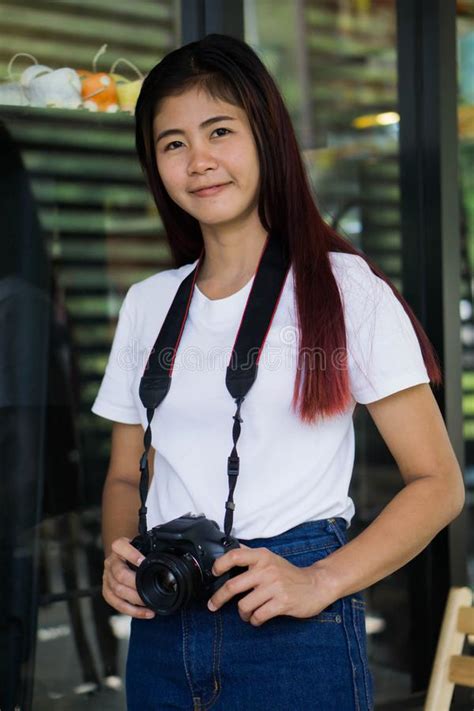asian teen is an amateur photographer practicing