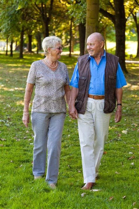 Mature Couple In Love Seniors Is Walking In A Park