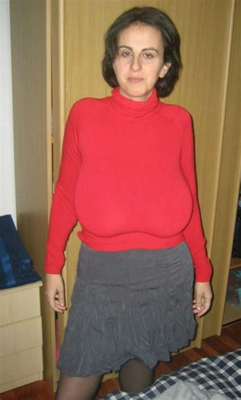 A Woman In A Red Sweater And Grey Skirt