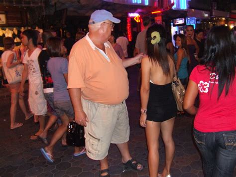 typical tourist couple old fat man renting a skinny