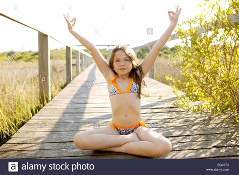 beautiful relaxed zen teen meditation in bikini summer