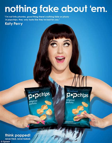 katy perry strategically places popchip packets over her chest in