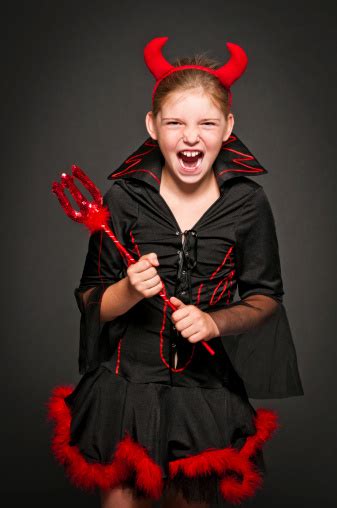 Girl In Devil Costume Laughing And Screaming Isolated On Black Stock