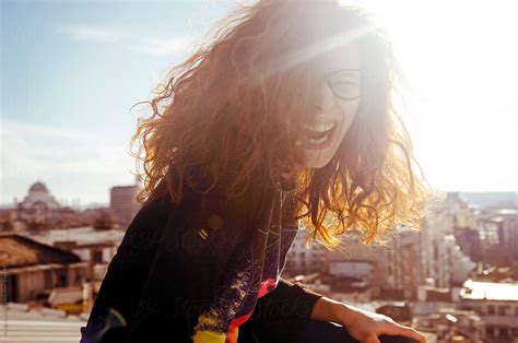 Redhead Girl Dancing And Laughing On The Rooftop By Stocksy