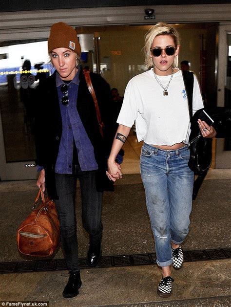 kristen stewart and alicia cargile hold hands as they jet back into los