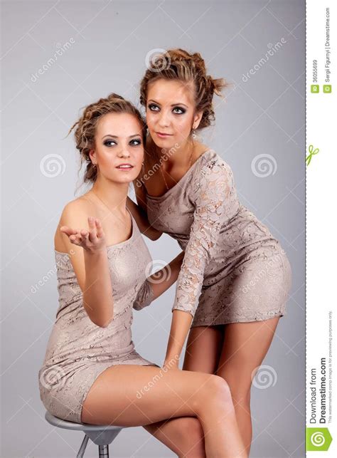 Two Girls Twins Isolated On The Grey Background Royalty