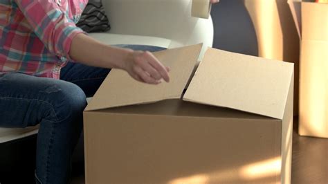 woman packing cardboard box hands using stock footage sbv 316755892