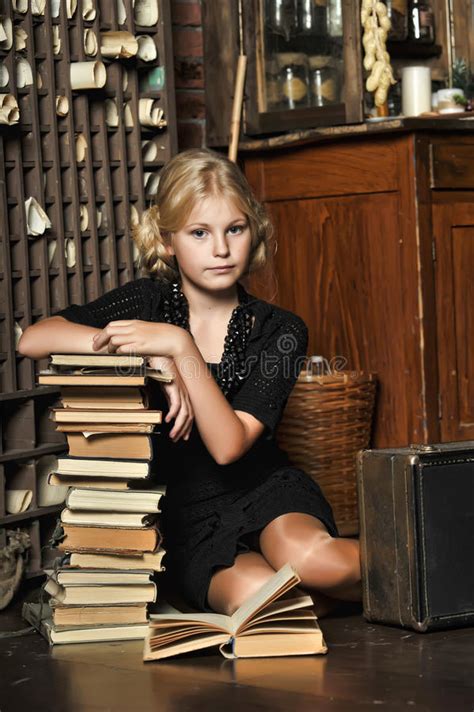 teen girl in retro style with a stack of books stock image