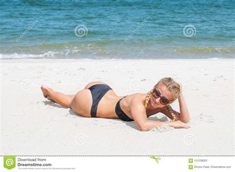 Beautiful Slim Woman In Bikini Lying On Sand On The Beach Stock Image