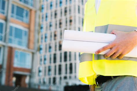 Free Photo Close Up Man In Safety Vest With Building Plans