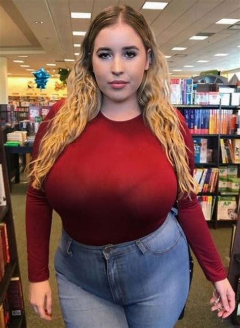 a woman standing in front of bookshelves with her hands on her hips and