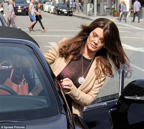 lisa vanderpump flashes her hot pink bra in a sheer black top as she