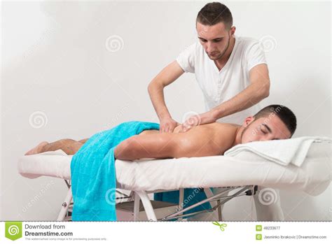 man having back massage in a spa center stock image image of cheerful