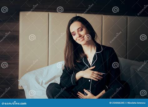happy pregnant woman resting in bed caressing belly stock image image