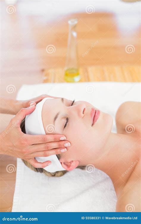 Beautiful Blonde Relaxing On Massage Table Smiling At Camera Stock
