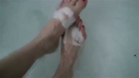 footfetish hot girl is rubbing her feet in the bathroom