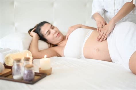 pregnant woman having massage in spa relax a massage to the belly of a