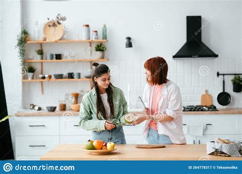 Two Girlfriends Cut Fruit In The Kitchen Stock Image Image Of Fresh