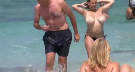divorced busty milf walking on the public beach with no