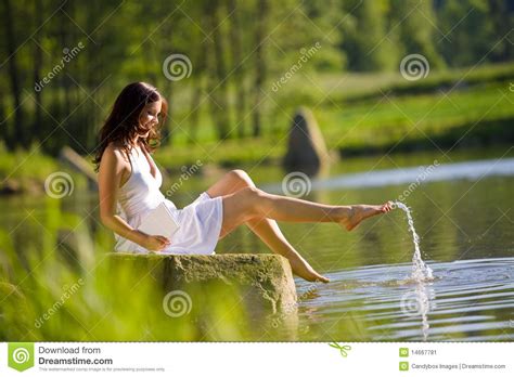 summer happy romantic woman sitting by lake stock image