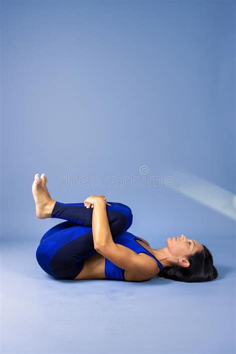 Female Yoga Instructor Does Floor Exercises In Gym Clothes Stock Image