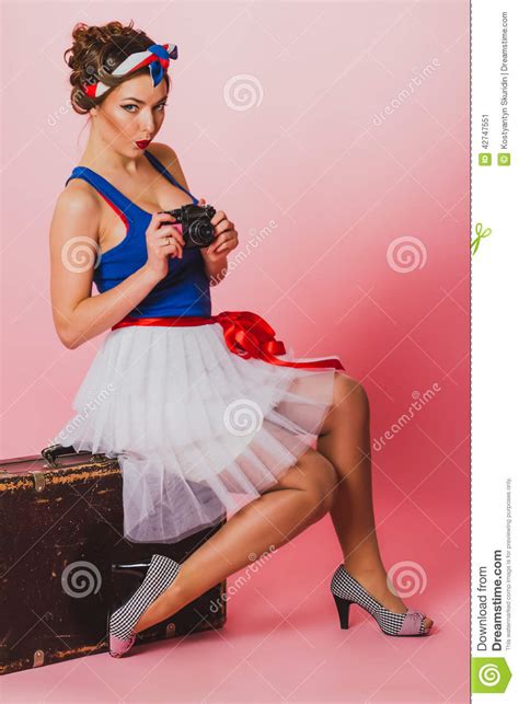 pin up girl with a film camera seat on a luggage stock image image of