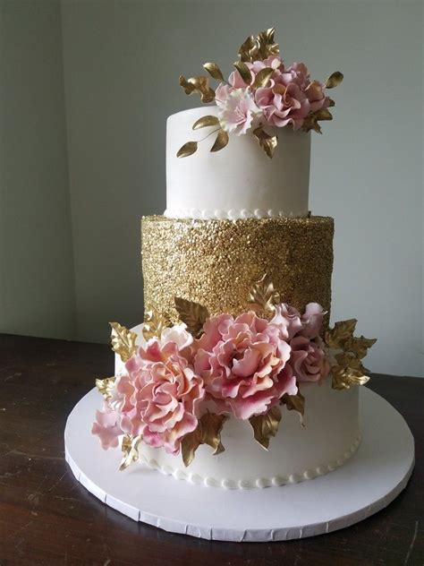 gold sequins and buttercream frosting decorated with gum paste roses