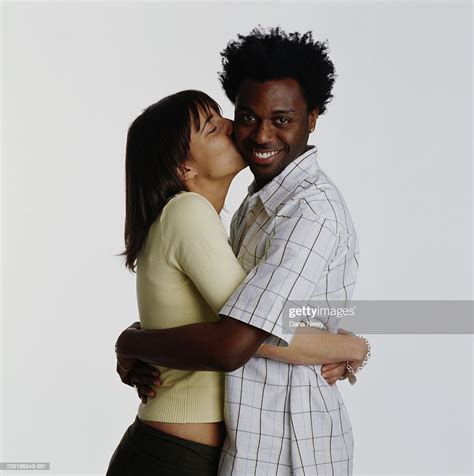 Young Couple Embracing Woman Kissing Mans Cheek Portrait Photo Getty