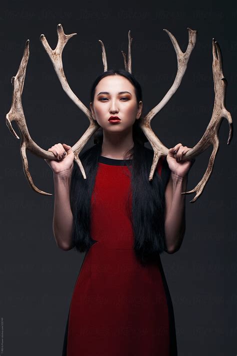 Portrait Of Asian Girl Holding Antlers By Stocksy Contributor Danil