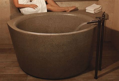 A Woman Sitting In A Large Stone Bath Tub