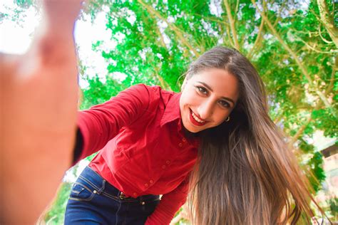 Free Photo Smiling Woman In Red Shirt And Blue Jeans