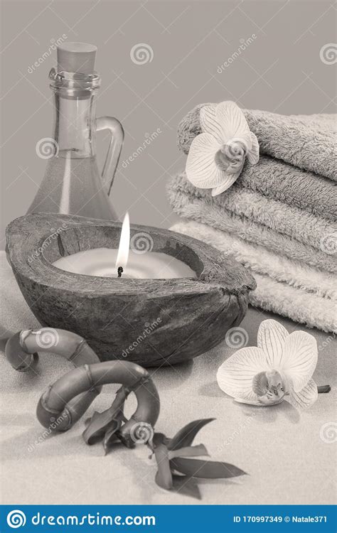black  white spa concept  burning candle stack  towels bamboo
