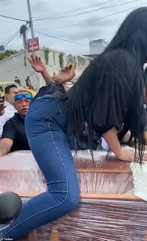 woman twerks on top of a coffin in front of cheering crowd