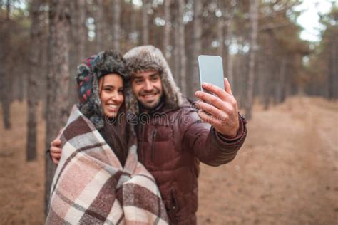 A Happy Couple Doing Selfie In The Autumn Forest Outdoors Stock Image