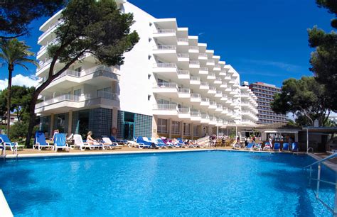 Relaxing By The Pool In The Sun In Mallorca Beach Hotel In Playa De
