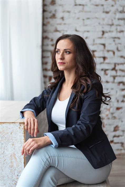 Portrait Of Pensive Business Woman Brunette In Casual Suit Sitting