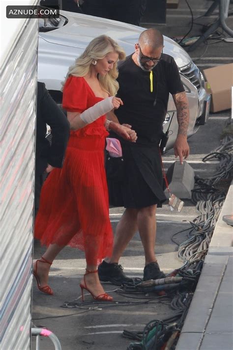 christie brinkley wearing a red dress while preparing for the dancing with the stars live show