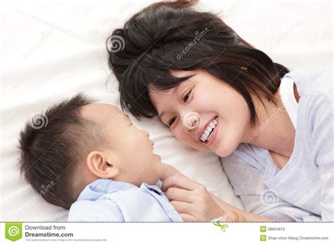 mother and son smile and look each other stock image