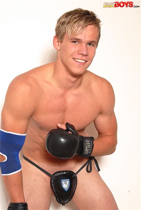 youn naked kickboxer posing in his sport uniform